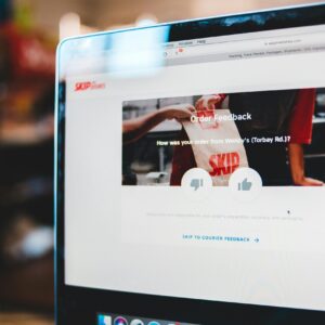 Online feedback form interface on laptop screen illustrating user interaction with delivery service.