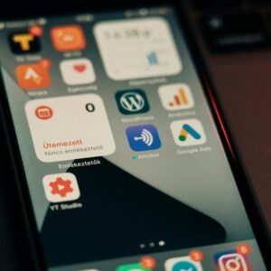 Close-up view of smartphone screen featuring various app icons and notifications.